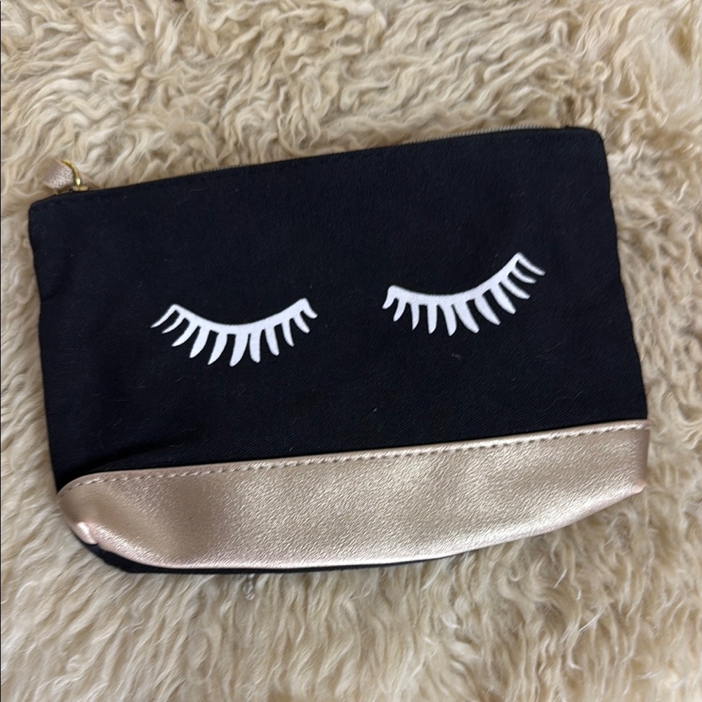 IPSY Black Pouch with Gold Zipper. Girlie design with eyelashes and rose gold.